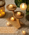 24 Pack Battery Operated Tea Lights With Timer For Home Decor, cozy warm white flickering LED candles on wooden stand.