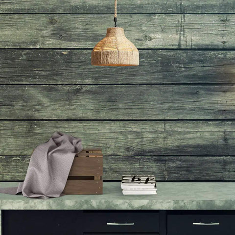 Coastal Rope Rattan Handwoven Pendant Lamp In Natural Finish hanging over a rustic table with decor items.