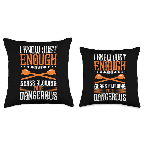 Two black throw pillows with the text 'I know just enough about glass blowing to be dangerous' in orange and white lettering.