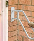 A Straight Up Rock Solid Wall Mounted Handrail Grab Bar For Indoor And Outdoor Steps Featuring Heavy Duty White Steel Railing, installed on wall.