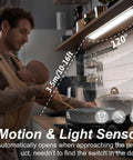 Father holding baby under Two Pack Under Cabinet Lights With Motion Sensor, 54 LED, 2500mAh Rechargeable, in a kitchen setting.
