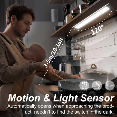 Father holding baby under Two Pack Under Cabinet Lights With Motion Sensor, 54 LED, 2500mAh Rechargeable, in a kitchen setting.