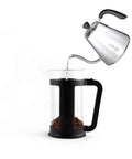 Smart French Press Coffee Maker With Borosilicate Glass Carafe Brew Ready 1 Liter 34 Ounce Capacity 8 Cup Dishwasher Safe Black Handle And Lid For Coffee Or Tea Infusions visible with water pouring into it.