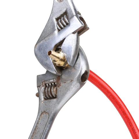 Four Piece Solid Brass Reusable Fittings For One Quarter Inch ID PU Hose held by wrench, air hose splicer end repair kit in use