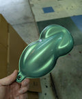 Premium Green Auto Paint Basecoat Midcoat Gallon Ready To Spray With Included Reducer for glossy paint sample on a hand.