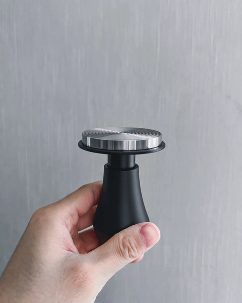 Spring Loaded Espresso Tamper 53.3mm With Ripple Base And Anodized Aluminum Handle held in hand