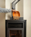 Person adding pellets to stove with 45 Degree Pellet Stove Vent Elbow In Stainless Steel Insulated Double Wall Design 3 Inch