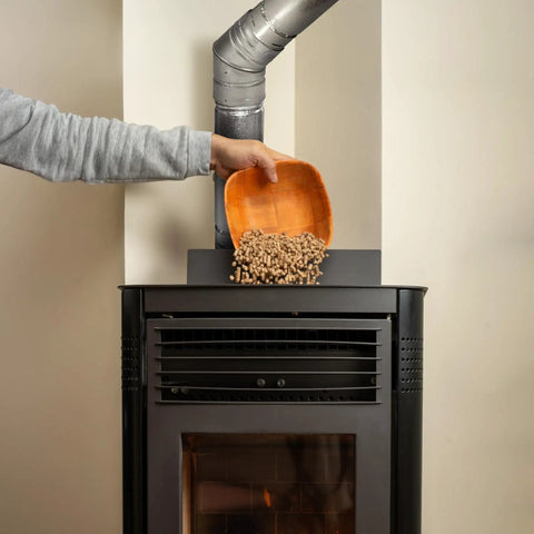 Person adding pellets to stove with 45 Degree Pellet Stove Vent Elbow In Stainless Steel Insulated Double Wall Design 3 Inch