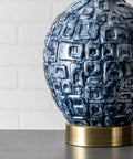 Close-up of blue ceramic base with textured pattern from Tucson 28 Inch Ceramic Table Lamp With Linen Shade For Living Room, Bedroom Or Entryway On Off Switch, End Table Lighting With Warm Ambient Glow And Cozy Vibe.