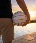 Golden White Volleyball Official Size 5 With Minimalist Design And Vibrant Colors For Street, Beach And Indoor Play held by person