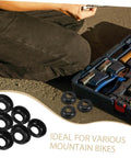 Close-up of black mountain bike rear axle steel washer kit next to toolkit, ideal for MTB hub maintenance and repair, 20 piece set.