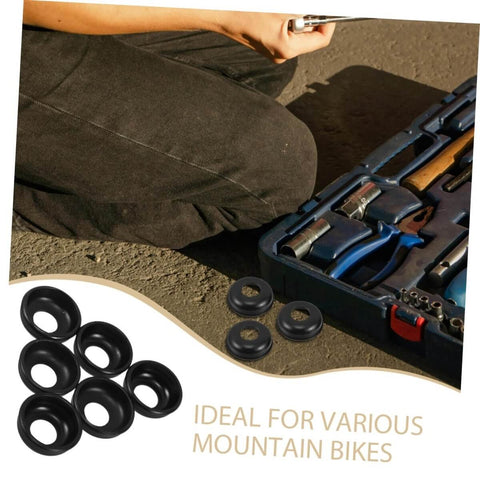 Close-up of black mountain bike rear axle steel washer kit next to toolkit, ideal for MTB hub maintenance and repair, 20 piece set.