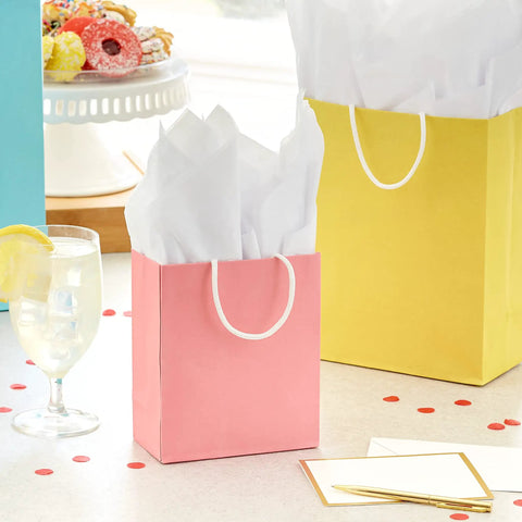 Pastel Color Recyclable Gift Bag Set With Eight Assorted Sizes For All Occasions, pink gift bag with white tissue paper on table