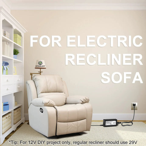 Beige leather electric recliner sofa with floor-mounted power adapter plugged into wall.