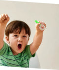 Child excitedly holding thumb type directional compass for outdoor navigation, portable hiking tool in clear acrylic.