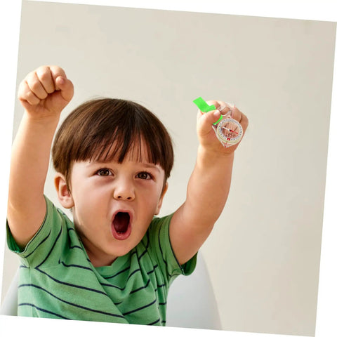 Child excitedly holding thumb type directional compass for outdoor navigation, portable hiking tool in clear acrylic.
