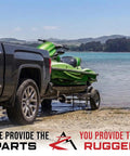 Pack Of Two Rugged Trailer Axle Kits With Four On Four Bolt Pattern Idler Hub And One And One Quarter Inch Round BT8 Spindle on a trailer with a green jet ski.