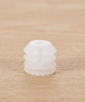 Close-up of a single white plastic dowel insert from the Plastic Dowel Inserts And Mounting Screws For Hinges Kit - M4x8mm White Dowels For Cabinet Doors, Furniture Fittings, Quick Fix For Stripped Holes, Replacement Hinge Dowels, Universal Fit With Expansion Plugs kit.