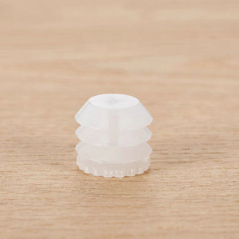 Close-up of a single white plastic dowel insert from the Plastic Dowel Inserts And Mounting Screws For Hinges Kit - M4x8mm White Dowels For Cabinet Doors, Furniture Fittings, Quick Fix For Stripped Holes, Replacement Hinge Dowels, Universal Fit With Expansion Plugs kit.