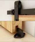 Close-up view of 6 Foot Sliding Barn Door Hardware Kit With Floor Guide And Spring Damping Stopper, Black Finish