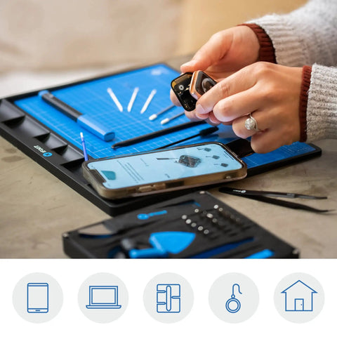 Hands using Magnetic FixMat Electronics Repair Mat With Dry Erase Grid And Sorting Bins Portable Screw And Part Organizer