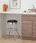 Heavy Duty 25-Inch Backless Swivel Bar Stool With Chrome Finish And Faux Leather Seat in kitchen setting