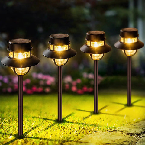 Outdoor garden with Solar Pathway Lights Outdoor 6 Pack Dope Bright White LED Landscape Lights illuminating the grass
