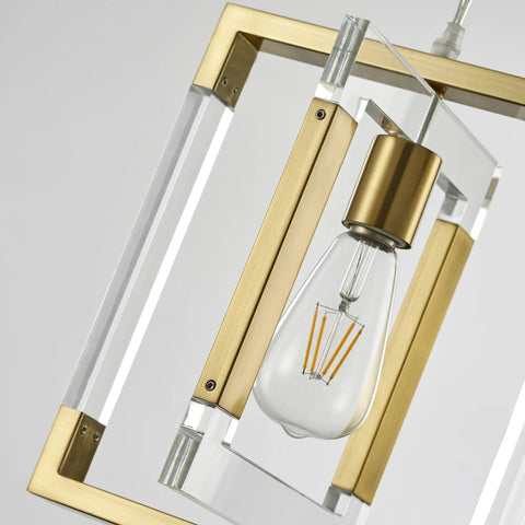 Close-up of Gold Pendant Light Chandelier With Brushed Brass Finish highlighting acrylic and metal frame, showing bulb.
