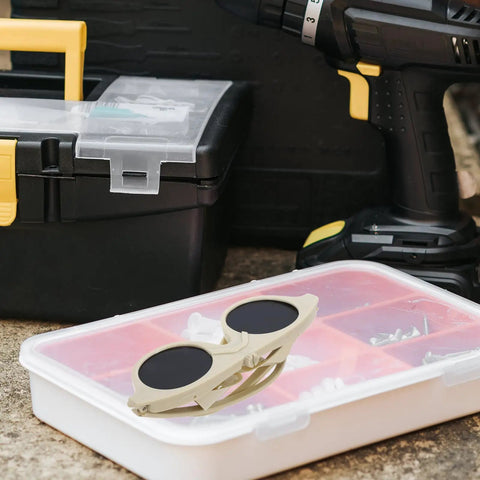 Built Tough Welding Glasses And Protective Goggles For Industrial Grinding, beige plastic frame on pink organizer.