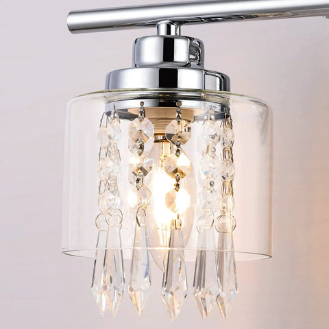 Lit Three Light Crystal Vanity Light Fixture with Clear Glass Shades and K9 Crystal Decor, close-up of chrome finish detail