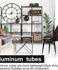 Aluminum tubes used in modern living room setup with black metal shelves, large clock, and geometric table design