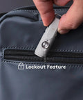 Hand placing Keychain EDC Flashlight Red USB C 650 Lumens Ultra Compact Aluminum Alloy Torch with lockout feature into bag pocket