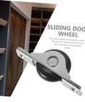 Close-up of a nylon and metal sliding door wheel, part of the 4 Pieces Sliding Door Wheel Pulley Track Roller Set For Wardrobe And Cabinet Doors Heavy Duty Steel And Nylon Hardware For Smooth Quiet Sliding High Wear Resistance Ideal Replacement For Closet Doors.