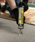 Man applying Textured Concrete Premium Elastomeric Filler And Sealant For Crack Repair In Interior And Exterior Concrete And Masonry, Waterproof And Weatherproof, Ready To Use, Gray, 10.1 Oz to a concrete crack.