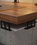 Slick Under Desk Laptop Storage Rack With Badass Sturdy Metal Iron Frame And Nonslip Grip Pads Heavy Duty Rolling Laptop Rack Organizer To Keep Your Desk Hella Organized And Super Sleek Modern Black Finish under a wooden desk, holding a laptop securely.