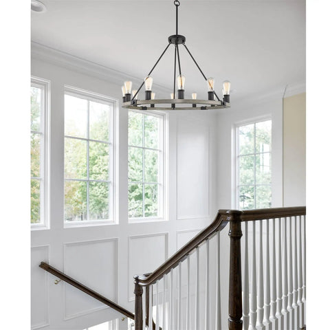 Homestead 25 Inch Six Light Wagon Wheel Chandelier With Gray Oak Wood Finish And Textured Black Accents in stairwell view