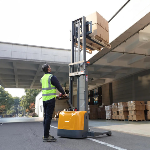 All Day Workhorse Full Electric Straddle Pallet Stacker And Warehouse Material Handler With 3300 Lbs Capacity And 98 Inch Lift Height lifting boxes in a warehouse.