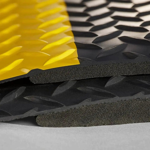 Close-up of Heavy Duty Anti Fatigue Floor Mat 2 By 7 Feet Extra Thick Fifteen Sixteenths Inch Diamond Plate Standing Pad, showing yellow border.