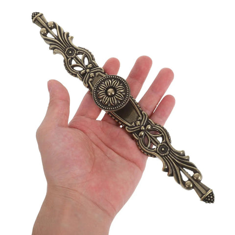 Hand holding Vintage Style Cabinet Handles 6 Pack Zinc Alloy Drawer Pulls For Kitchen Wardrobe Dresser Doors Retro Hardware Dope Vibe With Timeless Antique Finish Quality showing detailed design.