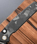 Folding Knife With 14C28N Steel Blade And Carbon Fiber Handle Go To EDC Knife shown on a wooden surface