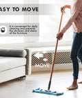 Person using mop next to extendable furniture dolly in living room, highlighting cleaning ease with Extendable Furniture Dolly With Telescoping Base.