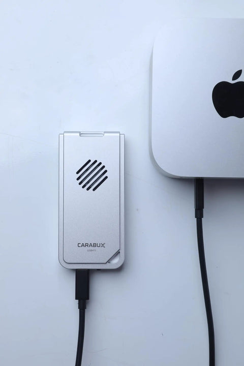 USB4 NVMe Enclosure With Active Cooling Fan And Solid Aluminum M.2 SSD Case For Mac iPad Pro connected to a workstation.