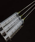 Three Pack 20 Milliliter Plastic Syringes With Slick Blunt Luer Lock Needles For Precision Liquid Transfer Heavy Duty Build on black background.