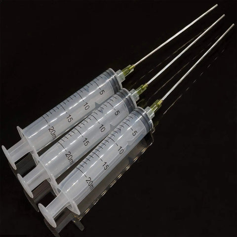 Three Pack 20 Milliliter Plastic Syringes With Slick Blunt Luer Lock Needles For Precision Liquid Transfer Heavy Duty Build on black background.