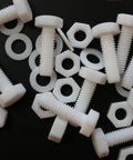Top Shelf Natural PTFE Hex Head Bolts With Matching Nuts And Washers M6 X 20mm on a black background, showing plastic fasteners.