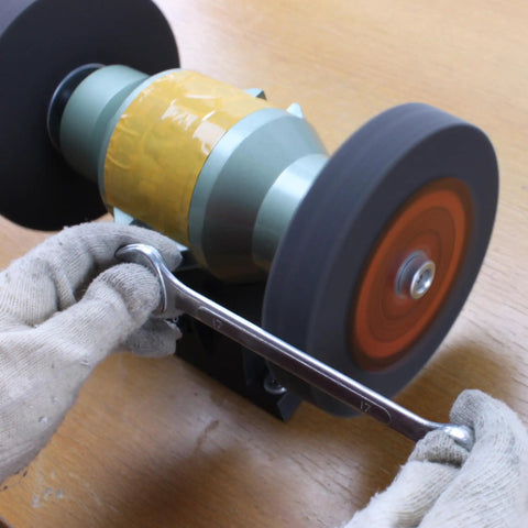 Premium Nylon Deburring Wheels 6 Inch, 180 Grit Silicon Carbide Buffing Pads 5 Pack in use on a bench grinder.