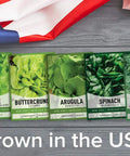 Five Pack Of Lettuce And Greens Seeds Including Arugula Spinach Kale Buttercrunch Romaine And More Non GMO With Plant Markers For Indoor Or Outdoor Garden on wooden background with USA flag