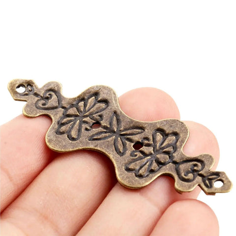 Close-up of Antique Bronze Corner Bracket from 150 Pcs Set for Wood Boxes Cabinets with Retro Vibe Vintage Style