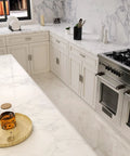 Modern kitchen with marble countertops and 10 pack adjustable cabinet handles in brushed nickel square satin finish drawer pulls.