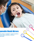 Disposable Plastic Dental Mirrors Set For Teeth Inspection, 40 Curved Angled Mouth Mirrors In Four Colors White Yellow Pink Blue, lightweight oral exam tool shown during child dental check.